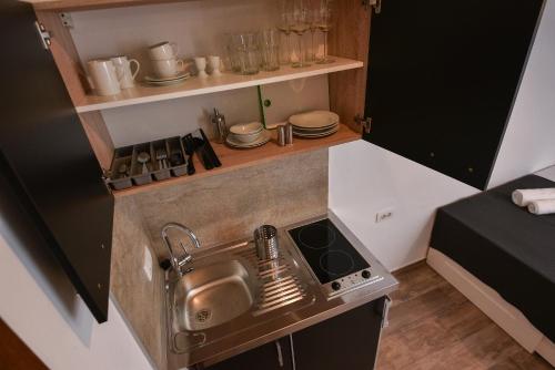 a small kitchen with a sink and a stove at Old Town Inn in Pula