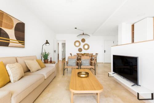 a living room with a couch and a fireplace at Beach apartment with terrace and private parking in Radazul