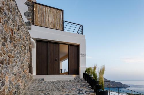 a house with a view of the ocean at Fedra Suites in Plakias
