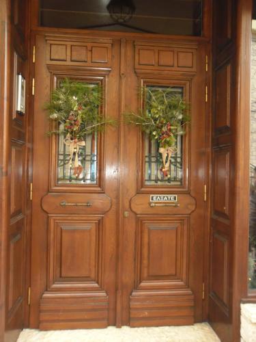 a wooden door with two doors with flowers on it at Marianna's Home Accommodation in Karpenision