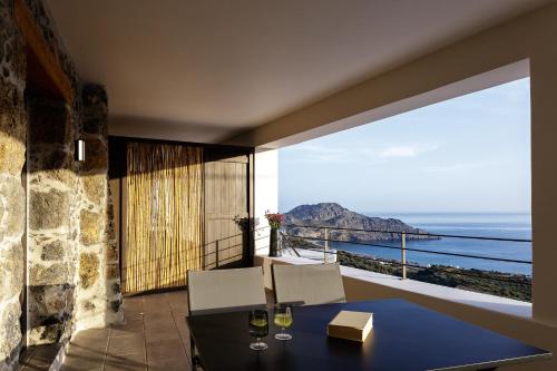 a dining room with a view of the ocean at Fedra Suites in Plakias
