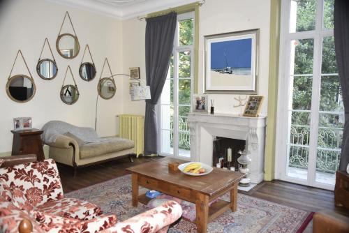 a living room with a couch and a fireplace at Beautiful large stylish villa centrally located in Pons in Pons