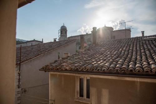 a view of roofs of buildings with the sun in the sky at B&B Relais Druda in Cagli