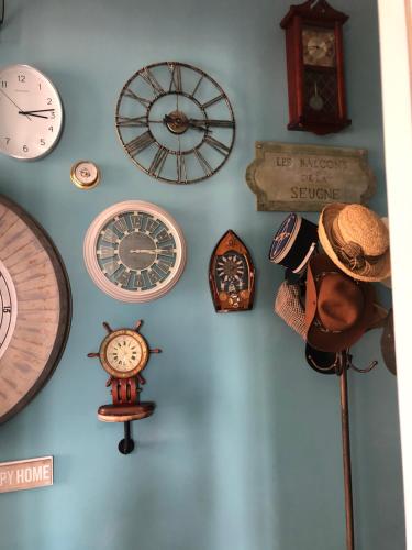 a bunch of clocks hanging on a wall at Beautiful large stylish villa centrally located in Pons in Pons