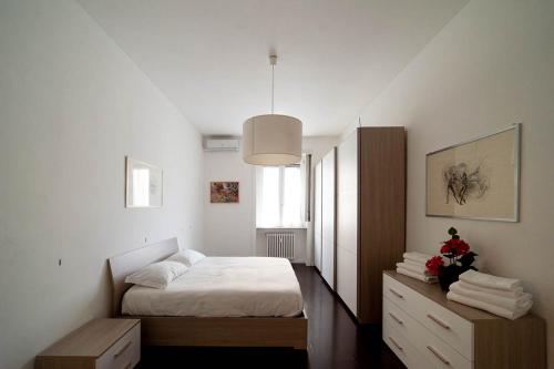 a bedroom with a bed and a dresser in it at Hbhall Residenze Darsena in Milan