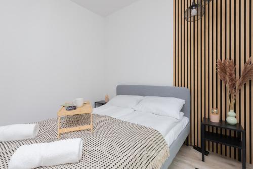 a bedroom with a bed with a black and white blanket at Awanport Estate Gdynia by Renters in Gdynia