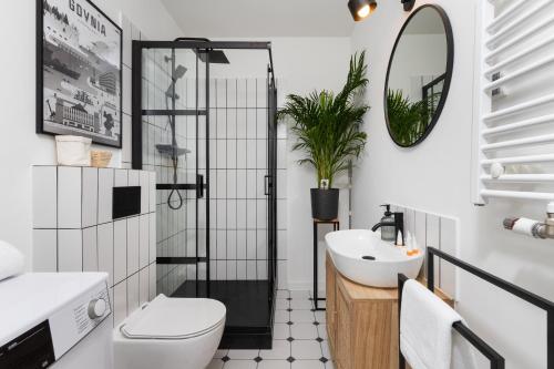 a bathroom with a toilet and a sink and a mirror at Awanport Estate Gdynia by Renters in Gdynia
