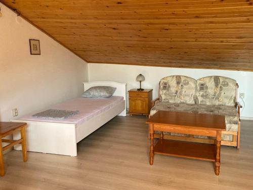 a bedroom with two beds and a wooden ceiling at Villa Apollonia in Sozopol