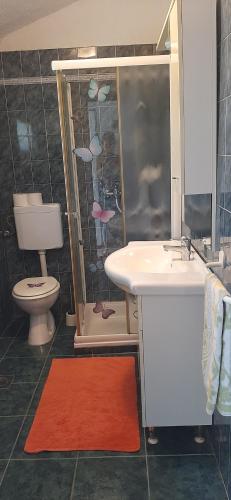 a bathroom with a sink and a toilet and a shower at Apartment Jasminka in Funtana