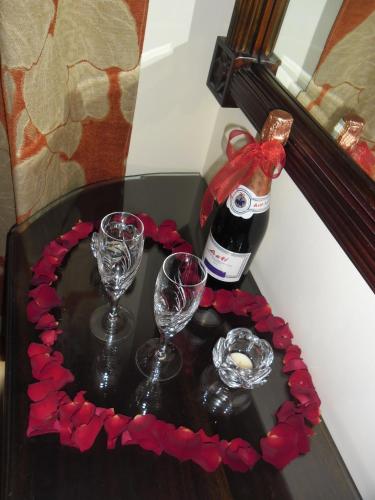 a table with two glasses and a bottle of wine at Marianna's Home Accommodation in Karpenision