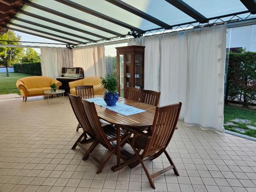a wooden table and chairs on a patio at B&B Villa Letizia in San Vito Rimini