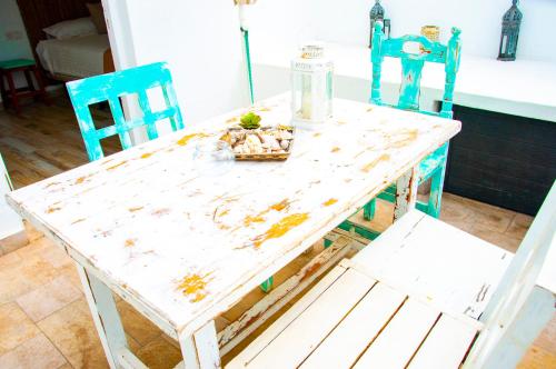 a white table with two chairs and a table with food on it at Turquesa Beach&Pool Apartaments in Playa Honda