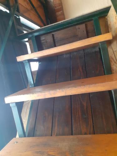 a wooden bench sitting on top of a table at Porodicni apartman,Viktor cafee in Šabac