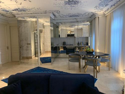 ein Wohnzimmer mit einem blauen Sofa und einem Tisch in der Unterkunft AB Residences -Cihangir Luxury Sapphire Apartment in Istanbul