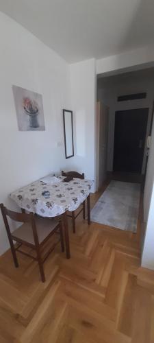 a living room with a table and a couch at Apartment Luka in Podgorica