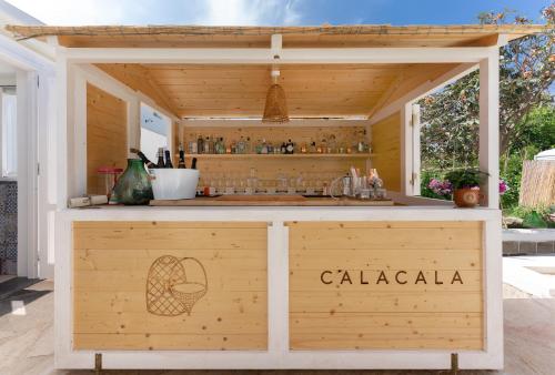 a wooden bar with a sign that says calaza at Cala Cala Rooms,Restaurant & Farm Experience in Procida