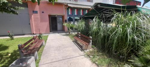 two benches sitting in front of a building at Apartment Luka in Podgorica