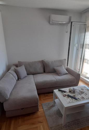 a living room with a couch and a coffee table at Apartment Luka in Podgorica