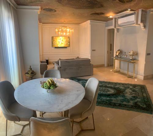 een eetkamer met een witte tafel en stoelen bij AB Residences -Cihangir Luxury Antique Apartment in Istanbul