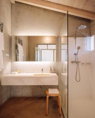 a bathroom with a large sink and a shower at Companhia das Culturas - Ecodesign & Spa Hotel in Castro Marim