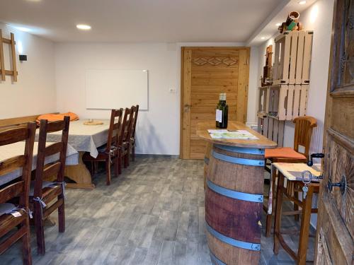 a restaurant with a table with a bottle of wine at Holiday House Zlačka Gorca in Pristava pri Mestinju