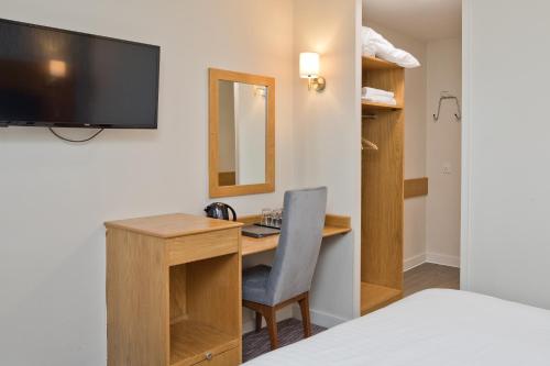 a bed room with a desk and a chair at Blue Bell Lodge Hotel in Middlesbrough