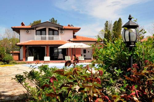 a house with a pool and a street light at Skupljen Resort: Enjoy the Freedom! in Vladimirci