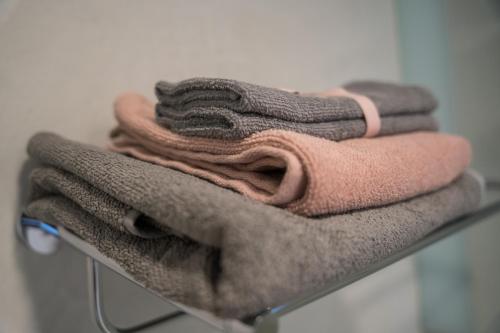 a pile of towels sitting on a rack at Blue Yvey Apartment in Torhout