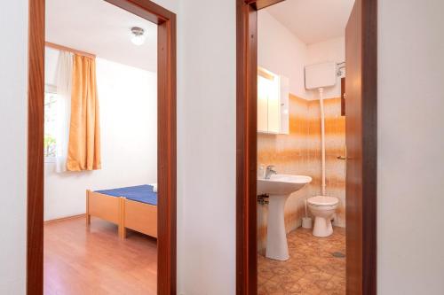 a bathroom with a toilet and a sink at Holiday Home Sansevic in Stari Grad