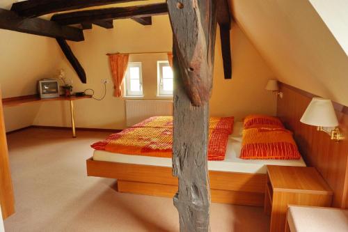 a bedroom with two twin beds in a attic at Pension Webstuhl in Deizisau