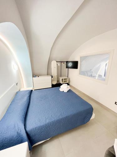 a bedroom with a blue bed in an attic at B & B Marina in Procida