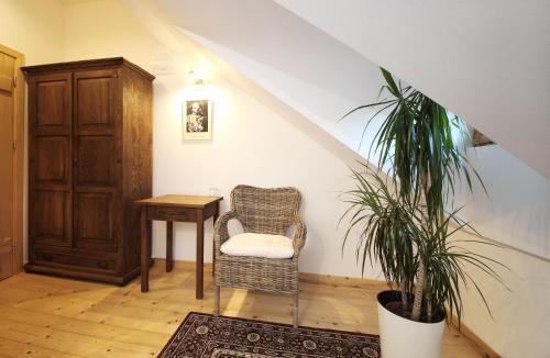 a room with a chair and a table and a plant at Ułańska Zagroda in Człopa
