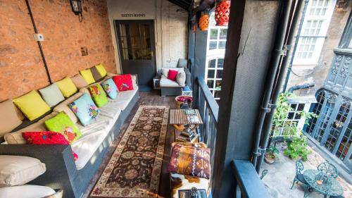 a living room with a couch on a balcony at Luttrell Arms in Dunster