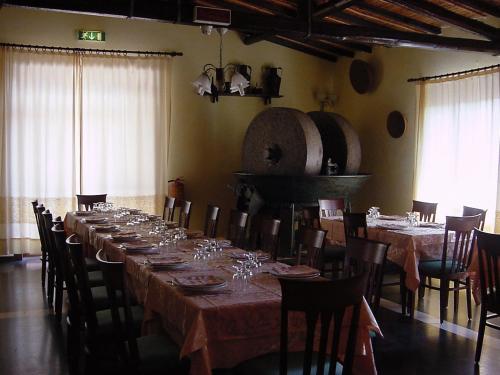 a large dining room with a long table and chairs at Sa Mola in Bonarcado
