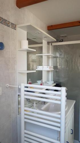 a bathroom with a white sink and a mirror at Les Mésanges in Royan