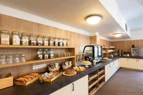 a bakery with a counter filled with lots of food at Hotel Svět in Třeboň
