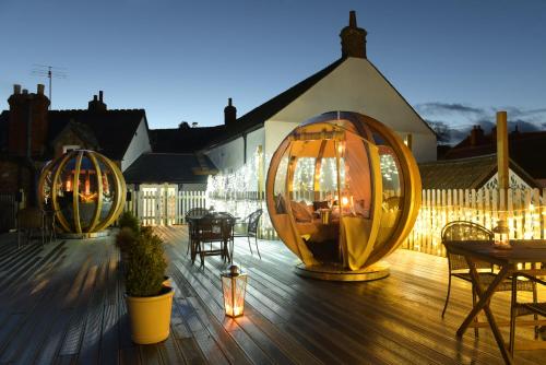 a deck with two large wooden spheres on a building at Luttrell Arms in Dunster