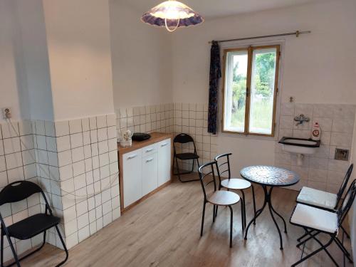 a kitchen with chairs and a table and a window at Prague Retro Challenge and Garden in Prague