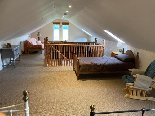 Zimmer im Dachgeschoss mit einem Bett und einer Treppe in der Unterkunft The Shed in Long Stratton