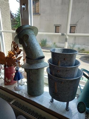 two metal buckets sitting on a window sill at Le Relais de Chassepierre in Chassepierre