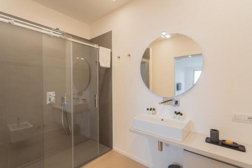 a bathroom with a shower and a sink and a mirror at La Vista Bonita by Rent All Como in Como