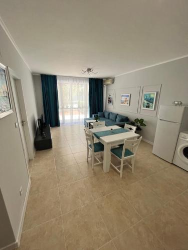 a living room with a table and chairs and a couch at TM Panorama Beach Apartments in Nesebar