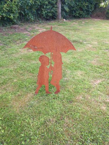 a statue of a person holding an umbrella at Le Relais de Chassepierre in Chassepierre
