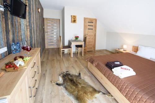 a bedroom with a dog laying on the floor at Willa Mysliwska in Krynica Morska