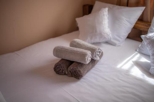 a stack of towels sitting on a bed at Etno Selo Svodje in Vlasotince