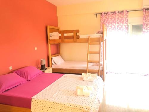 a bedroom with two bunk beds and a ladder at Veizi's Apartments in Himare