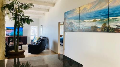 een woonkamer met een groot schilderij aan de muur bij Sea View Luxury Penthouse in Ballito