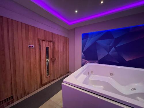 a bathroom with a large tub with purple lighting at Dream Lagoon Resort & Aqua Park in Marsa Alam City