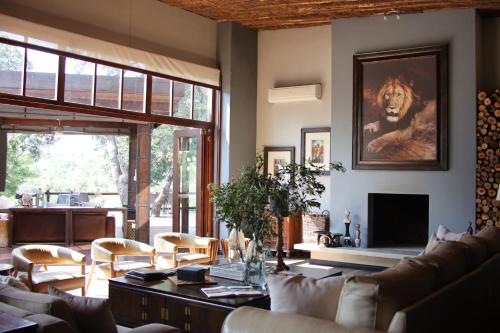 a living room with a couch and a tv at Karongwe - Becks Safari Lodge in Hoedspruit