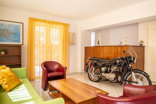 a living room with a motorcycle parked in it at Sea View Hotel in Alykes